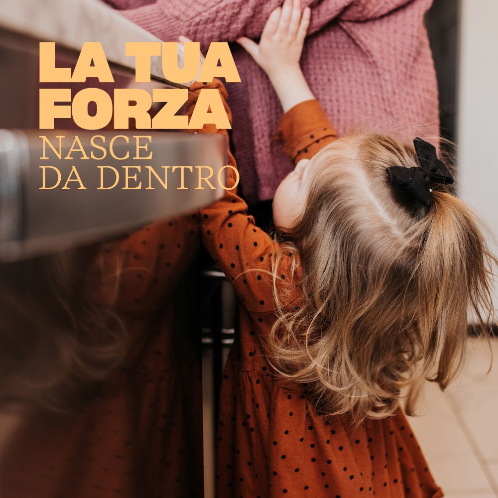 Bambina che allunga la mano verso una persona.