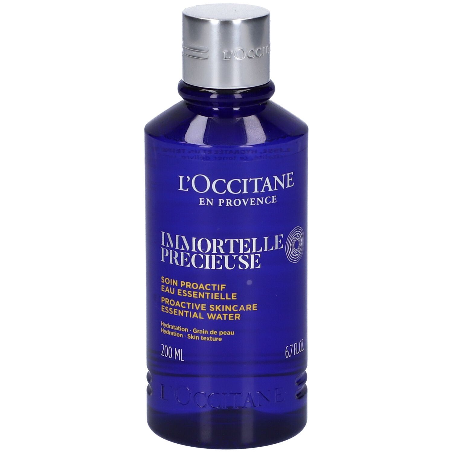 Flacone blu con tappo argentato. Scritta: L'Occitane, Immortelle Précieuse, 200 ml, 6.7 FL.OZ.