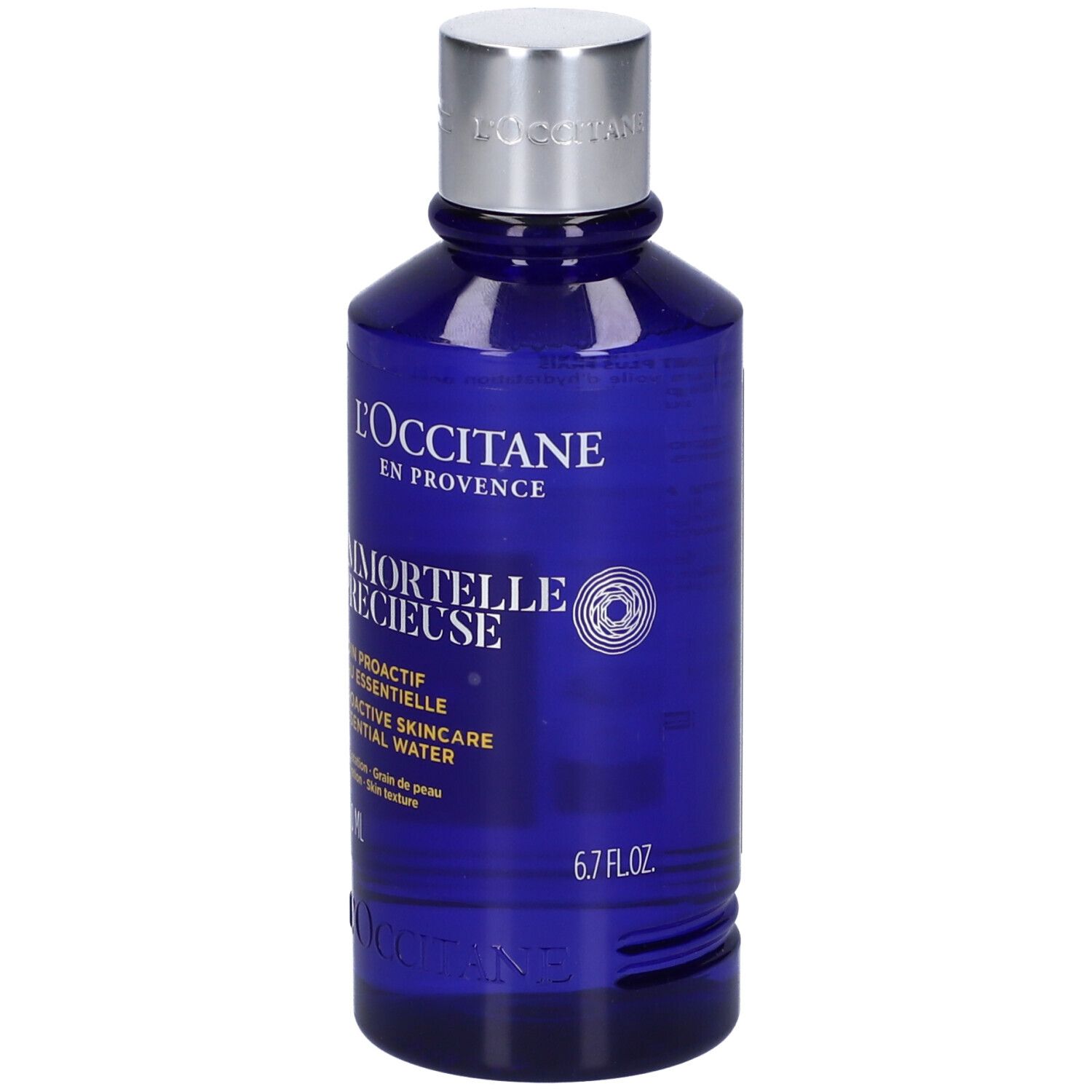 Flacone blu con tappo argentato. Scritta: L'Occitane, Immortelle Précieuse, 6.7 FL.OZ.