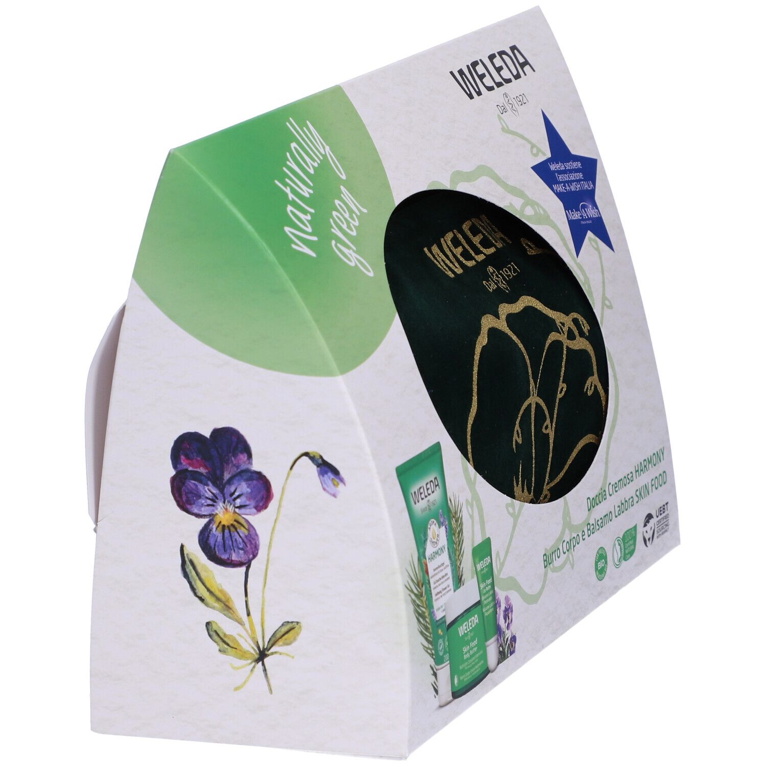 Confezione regalo Weleda angolata. Scritta Naturally Green, Weleda. Con fiore e logo Make-A-Wish. Testo in italiano.