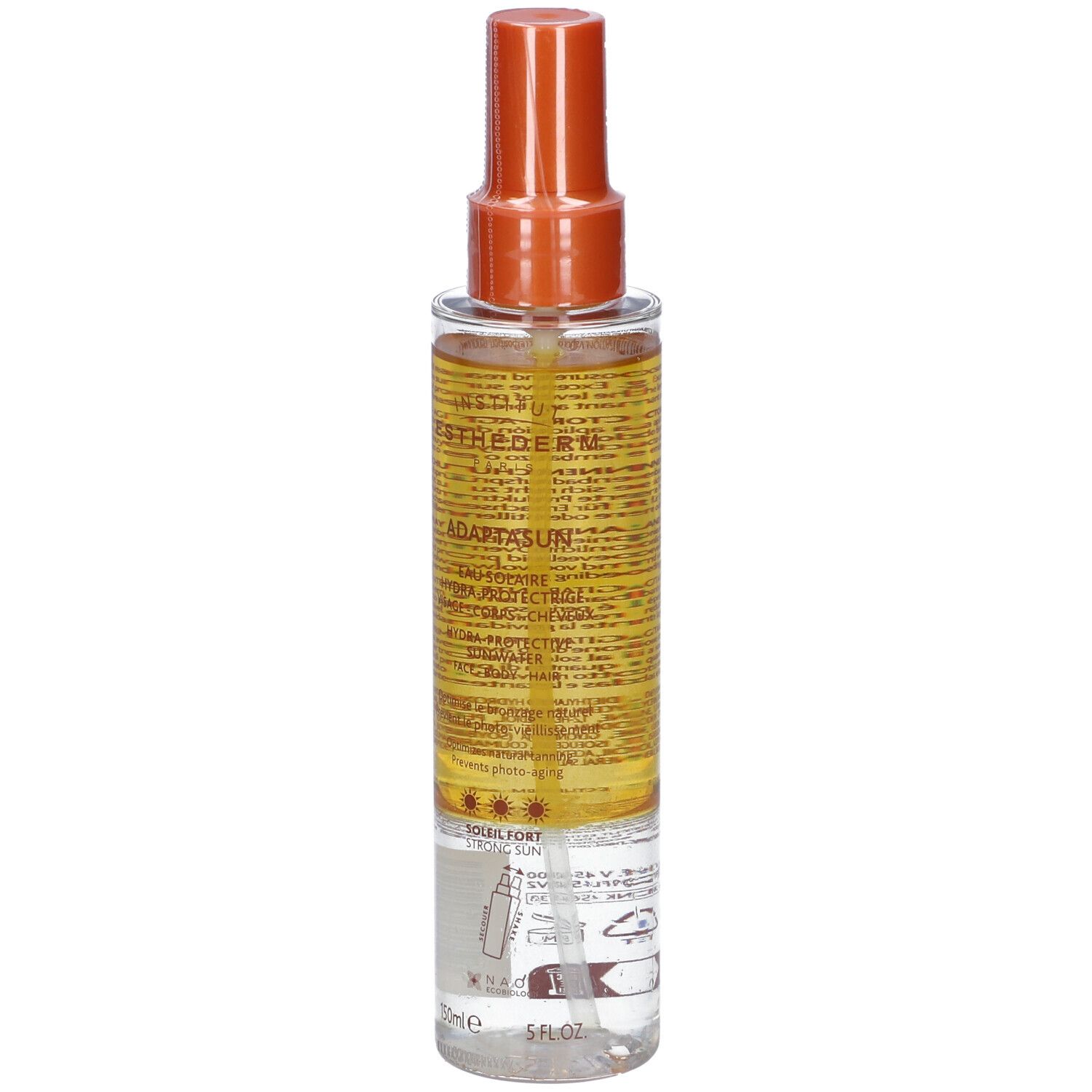 Flacone spray di crema solare. Contenitore trasparente con erogatore arancione. Scritta: Adaptasun Eau Solaire Hydra-protectrice.
