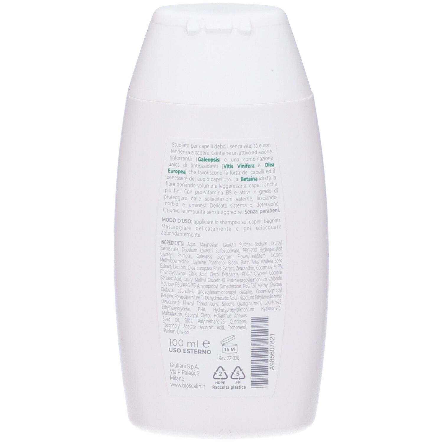 Retro di un flacone di shampoo bianco. Testo in verde e nero. Ingredienti e istruzioni per l'uso.