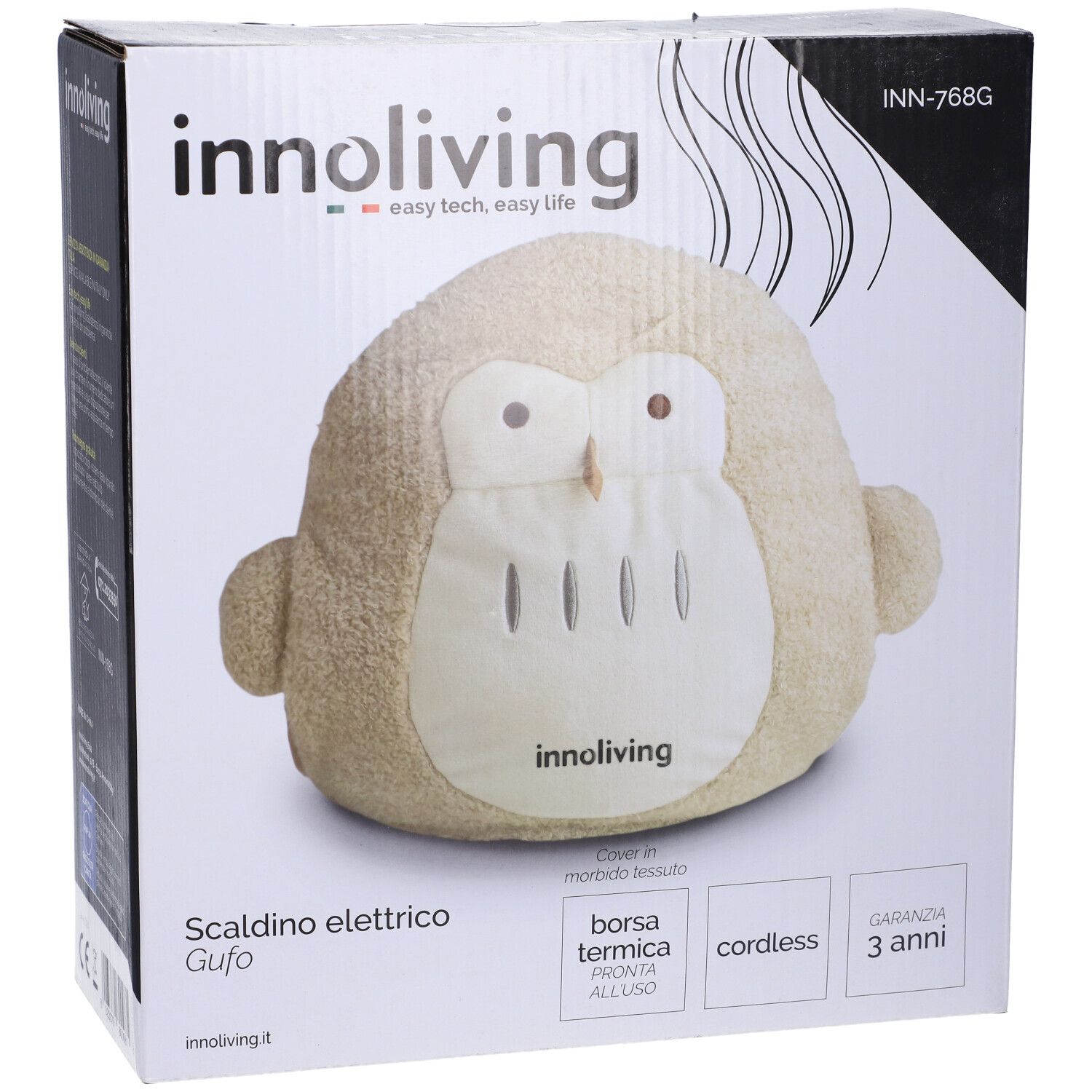 Cuscino termico a forma di gufo beige nella confezione. Marchio: Innoliving. Testo: Scaldino elettrico Gufo, Borsa termica, cordless, 3 anni garanzia.