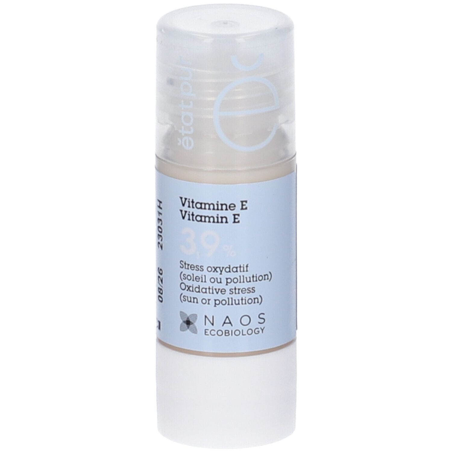 Flacone cilindrico con etichetta blu. Scritta: Vitamina E 3,9%. Logo NAOS Ecobiology. Tappo trasparente.