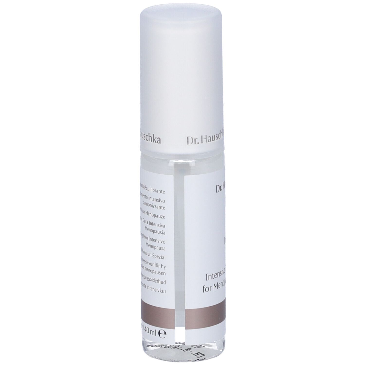 Flacone trasparente con tappo bianco. Scritte multilingue. Parte inferiore marrone.