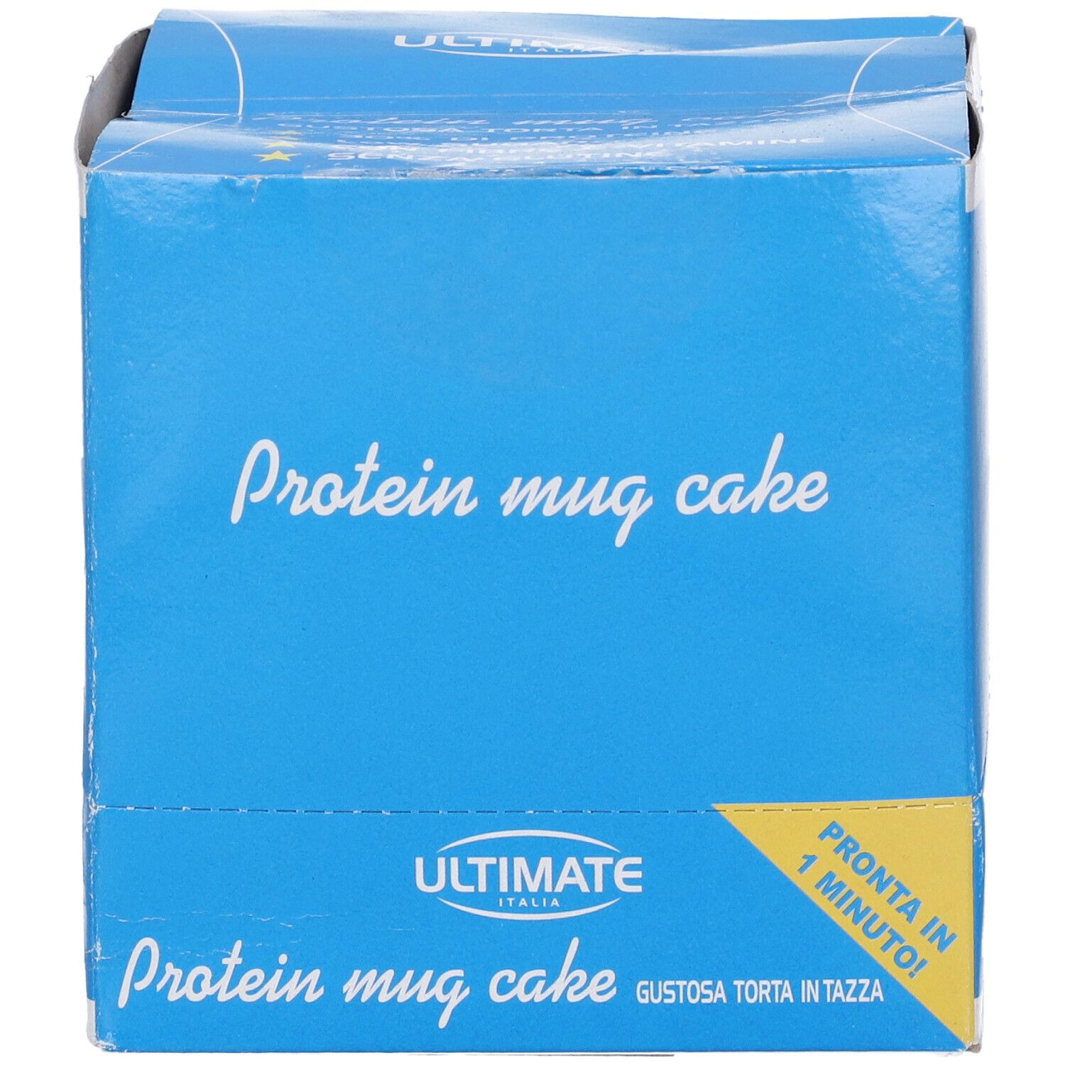 Scatola blu con scritta "Protein mug cake". Scritta "Ultimate Italia". Etichetta gialla "Pronta in 1 minuto!".
