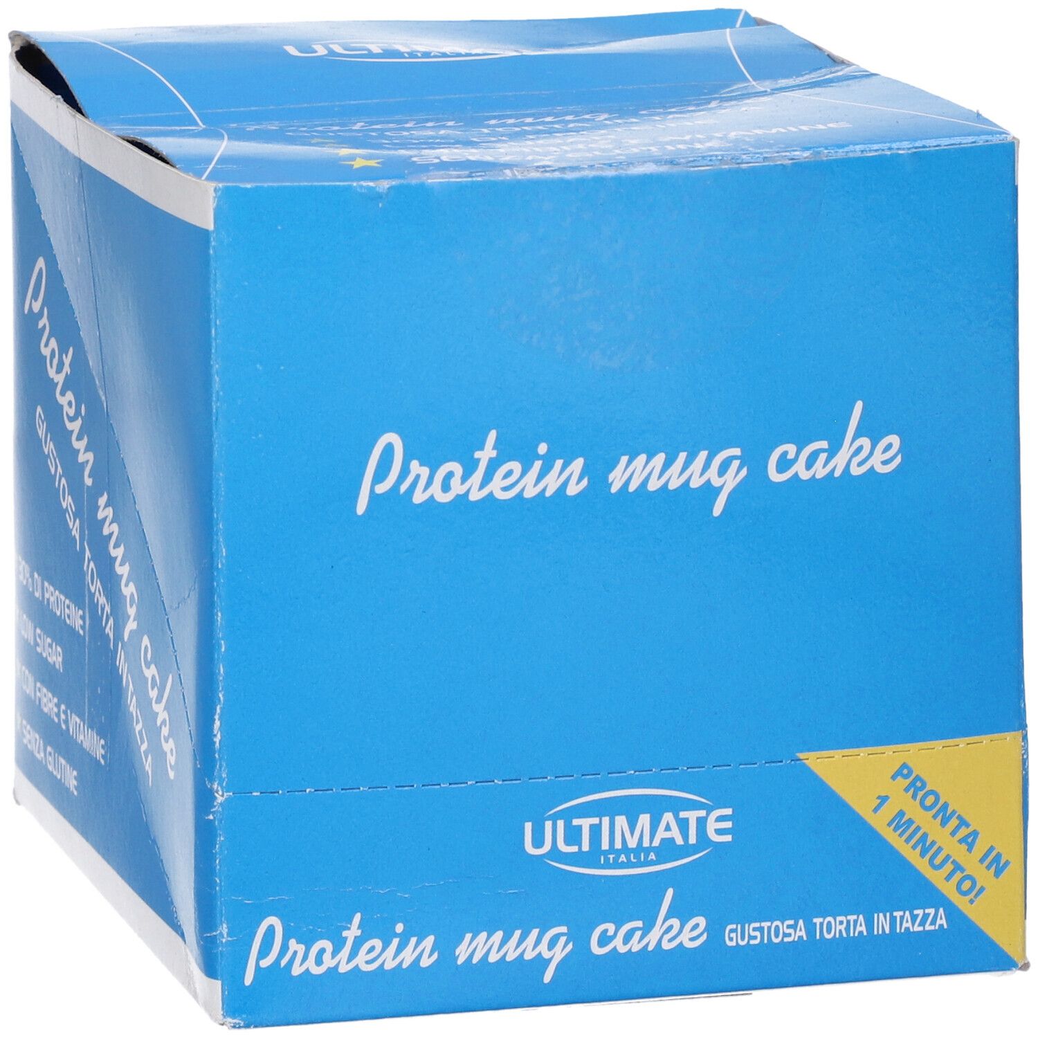 Scatola blu con scritta "Protein mug cake". Scritta "Ultimate Italia". Etichetta gialla "Pronta in 1 minuto!".
