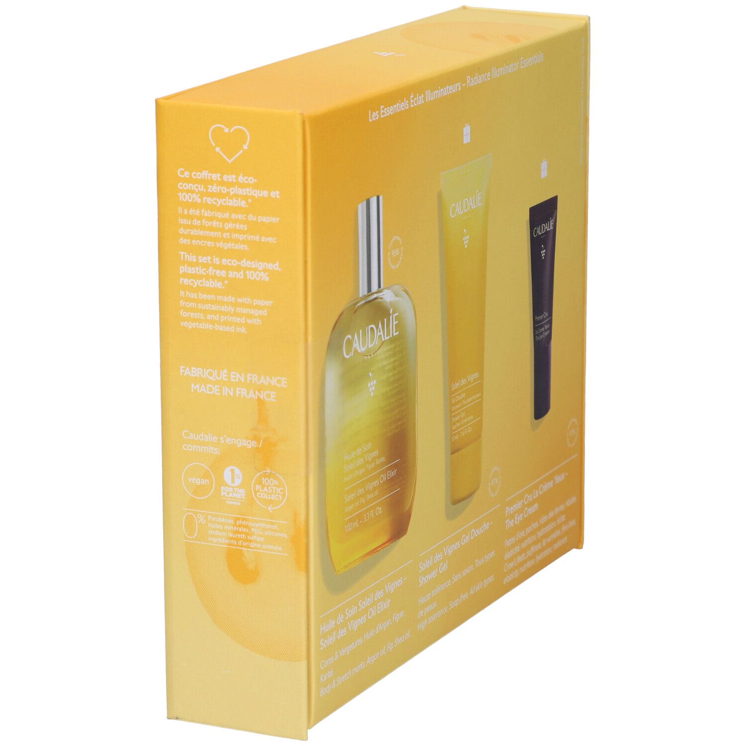 Confezione regalo gialla con tre prodotti. Bottiglia, tubo e tubo crema occhi. Logo Caudalie e nomi dei prodotti visibili.