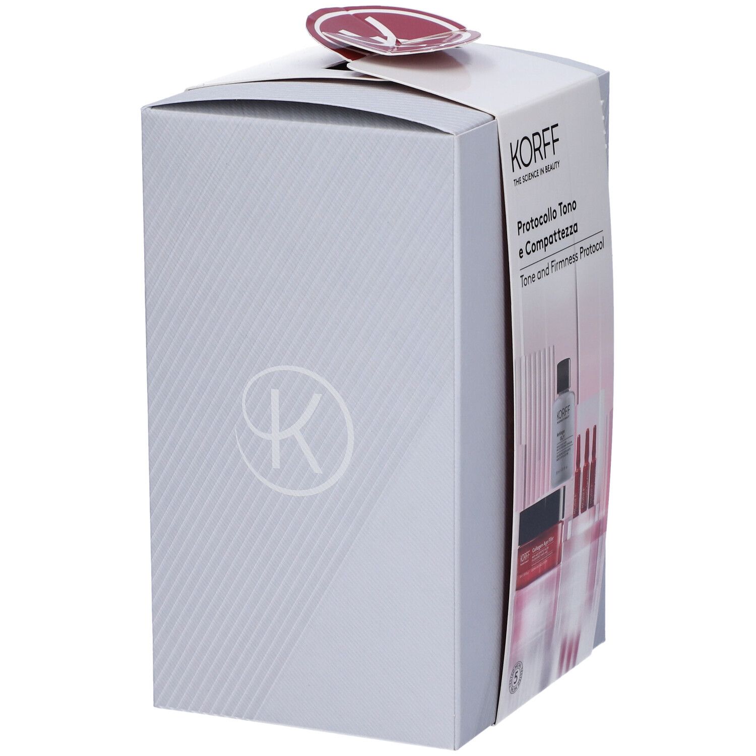 Confezione regalo grigia KORFF. Logo visibile. Contiene prodotti. Forma arrotondata. Adesivo bianco con logo. Testo: Protocollo Tono e Compattezza.