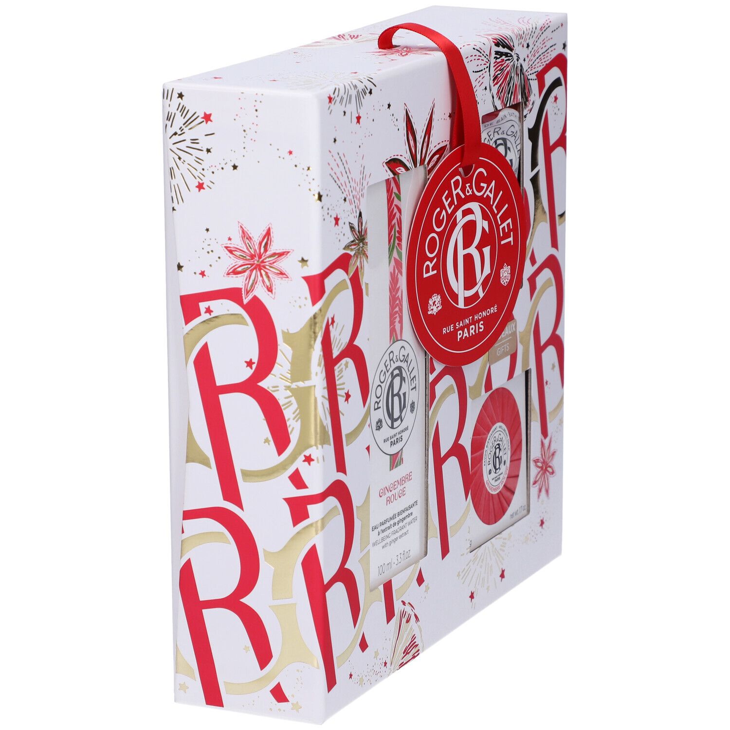 Confezione regalo, vista laterale obliqua. Nastro rosso con etichetta. Confezione decorata in rosso e oro. Contiene vari prodotti.