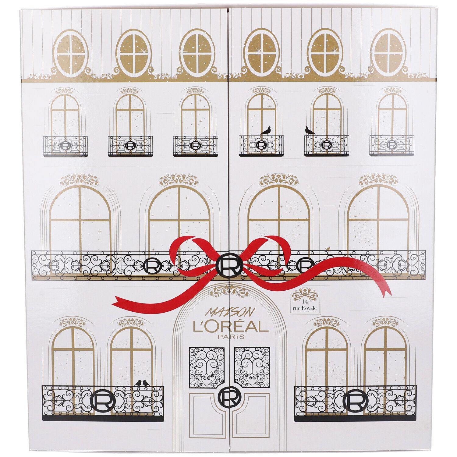 Calendario dell'Avvento bianco con design facciata, fiocco rosso e dettagli dorati. Scritta Maison L'Oréal Paris.