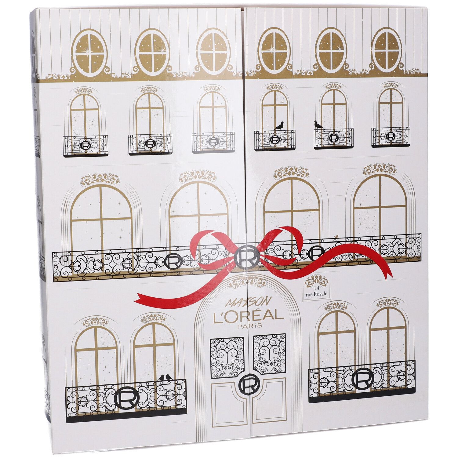 Calendario dell'Avvento bianco con design facciata, fiocco rosso e dettagli dorati. Scritta Maison L'Oréal Paris.
