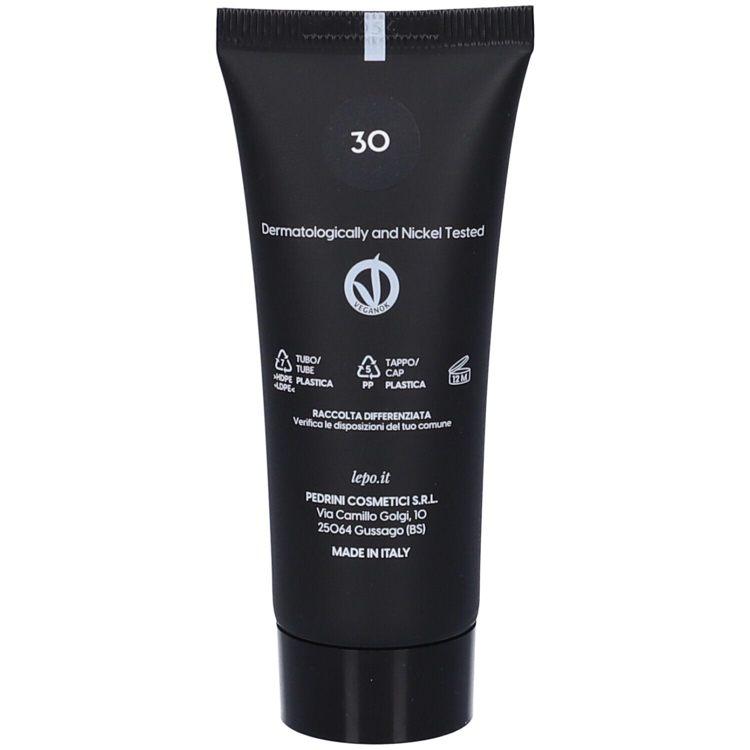 Retro del tubo nero. Testo: Dermatologicamente e Nickel Tested. Simboli di riciclaggio.