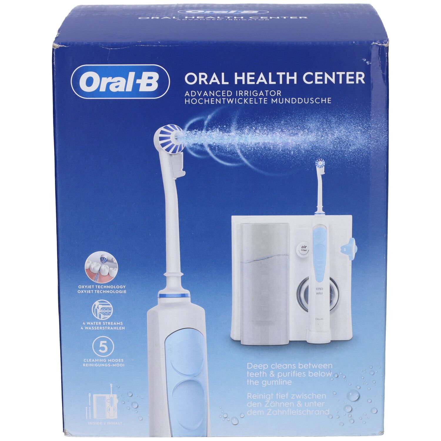 Scatola blu con logo Oral-B e immagine del prodotto. Contiene idropulsore e spazzolino elettrico. Testo: Oral Health Center.