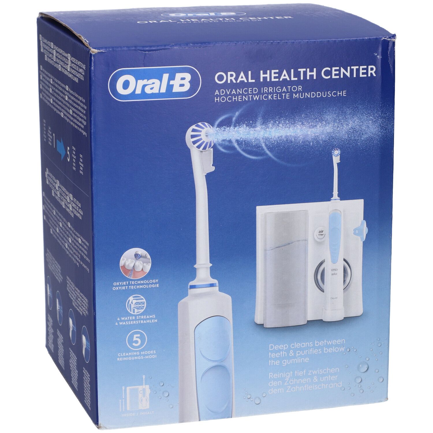 Scatola blu con logo Oral-B e immagine del prodotto. Contiene idropulsore e spazzolino elettrico. Testo: Oral Health Center.