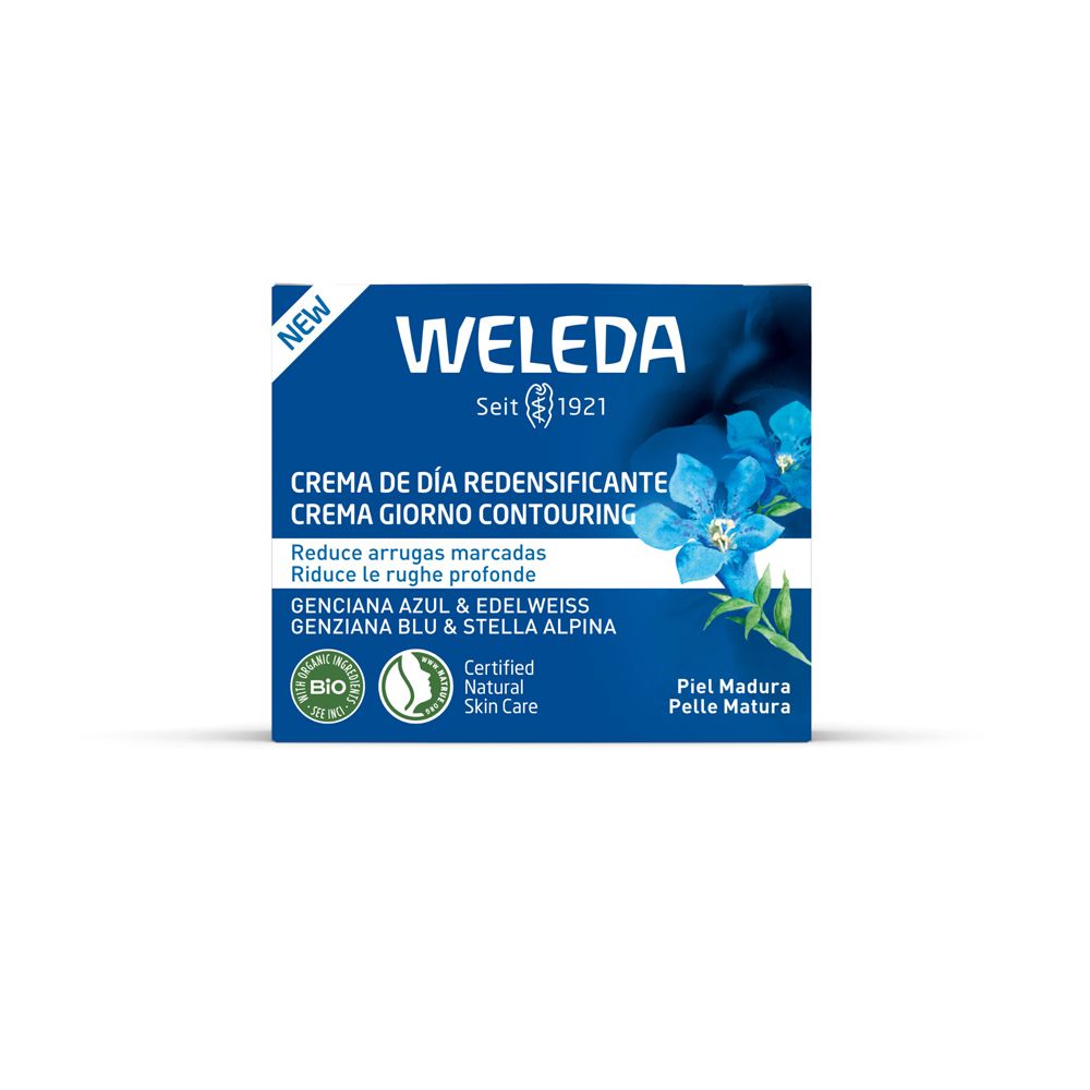 Scatola blu con scritta bianca WELEDA. Testo multilingue. Fiore blu. Sigillo bio.