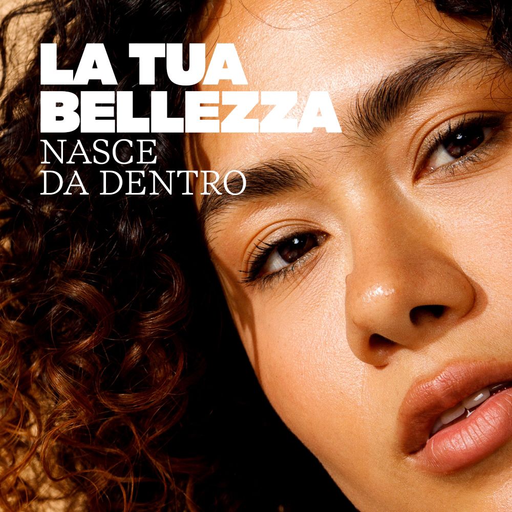 Primo piano di una donna con pelle radiosa, che sottolinea la bellezza interiore.