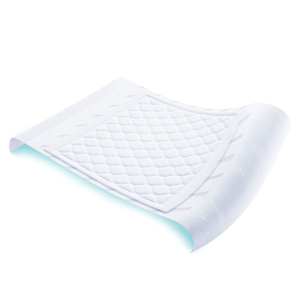 Traversa bianca per incontinenza con superficie a rilievo. Rettangolare, angoli arrotondati. Leggermente curva.