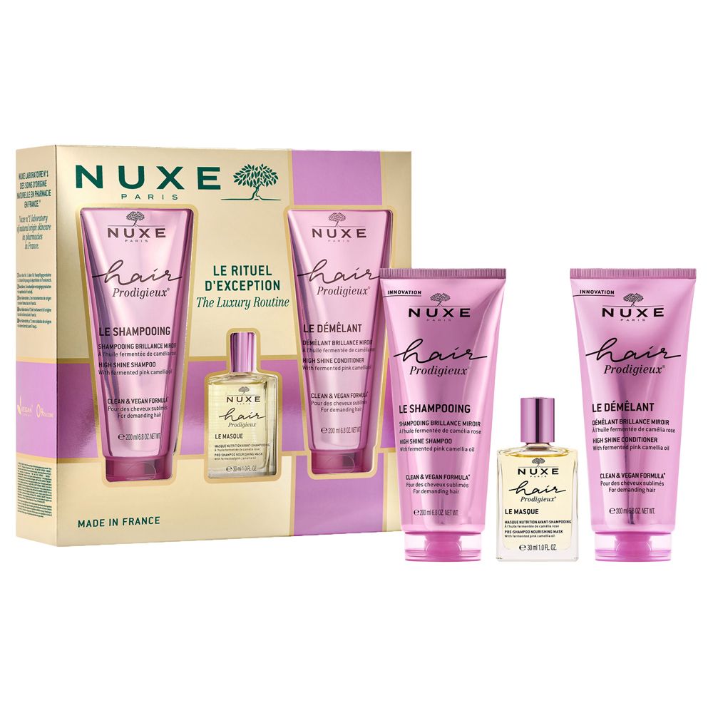 Confezione regalo Nuxe Hair Prodigieux. Quattro tubi e una bottiglia. Confezione oro e viola.