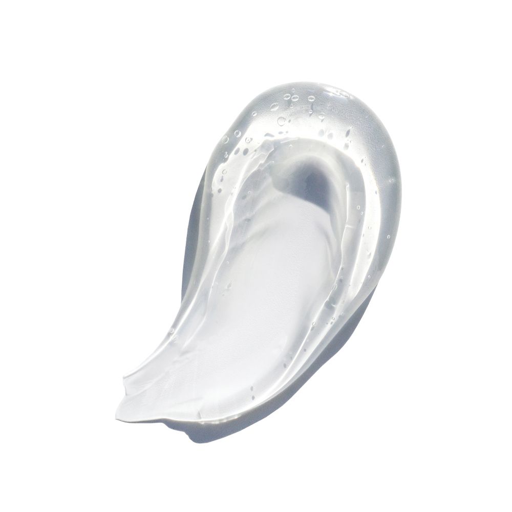 Macchia di sostanza trasparente simile a gel su sfondo bianco. Consistenza leggera, a forma di onda. Nessun'altra caratteristica.