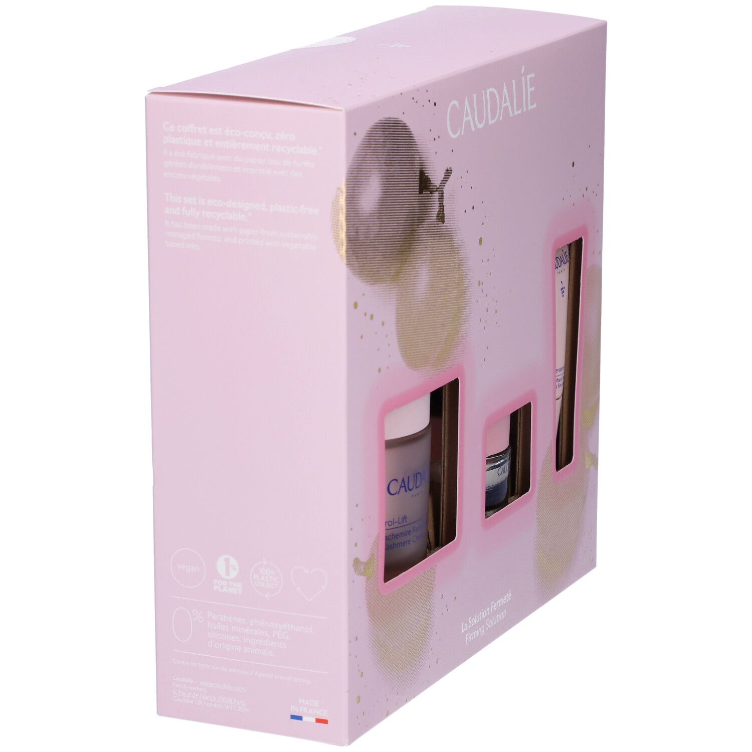 Vista laterale di confezione regalo rosa Caudalie. Tre aperture mostrano i prodotti. Marchio e nomi prodotti visibili.