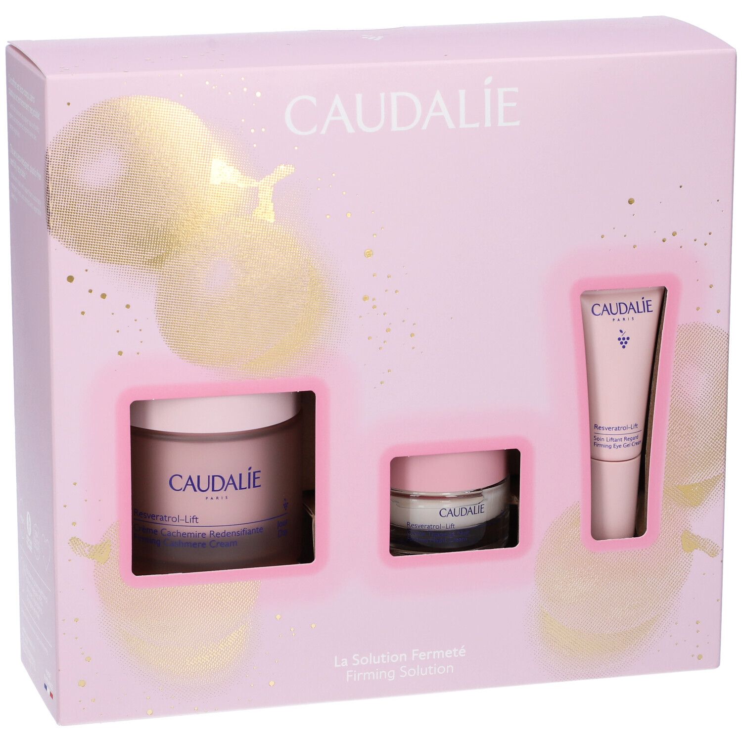 Confezione regalo rosa con tre prodotti Caudalie. Contiene vasetto crema, vasetto piccolo e tubo. Marchio Caudalie visibile.