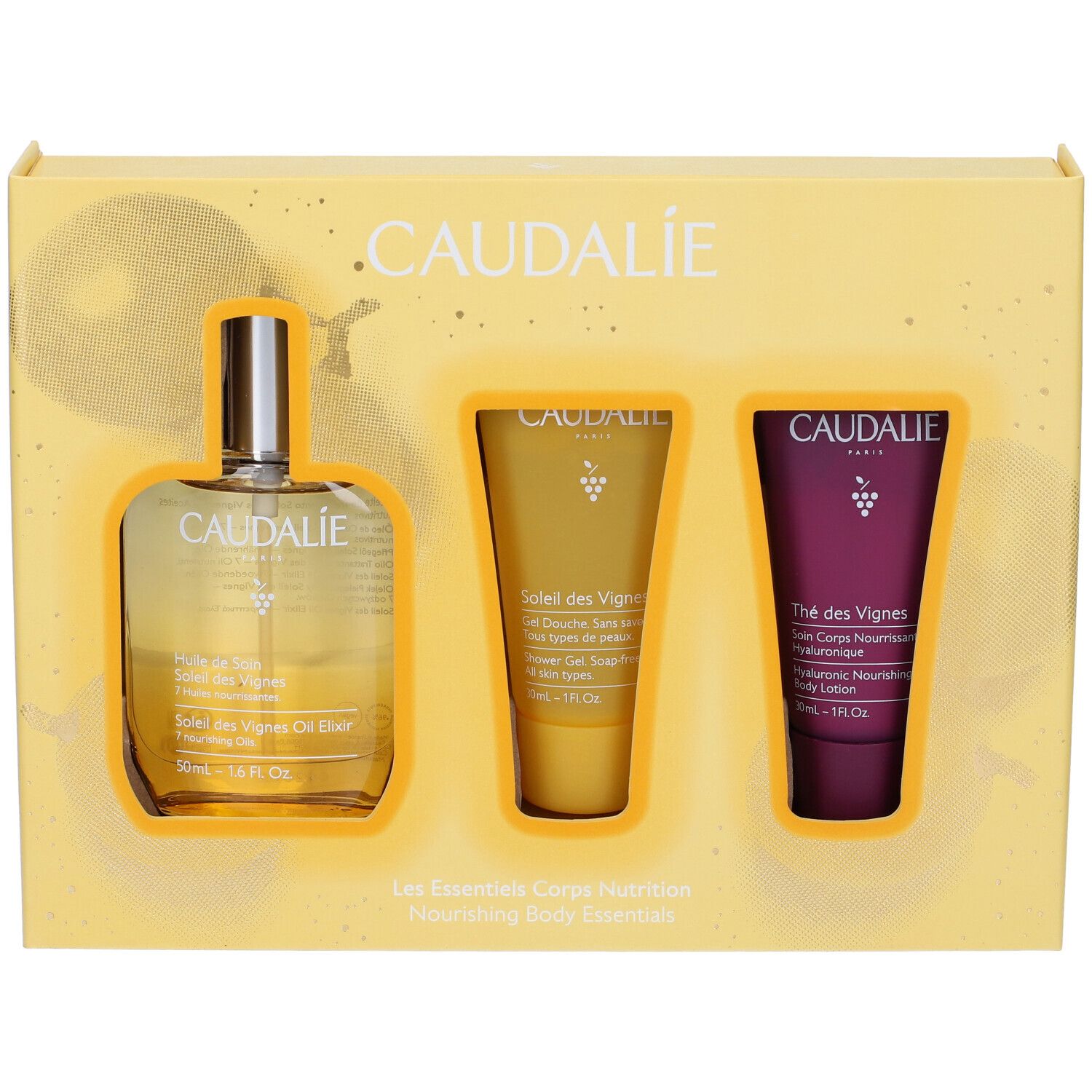 Confezione regalo gialla con tre prodotti: olio, gel doccia e lozione. Logo Caudalie e nomi dei prodotti visibili.