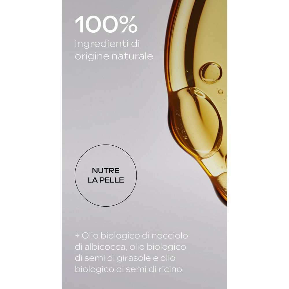 Primo piano di liquido. Testo: 100% ingredienti di origine naturale. Nutre la pelle.