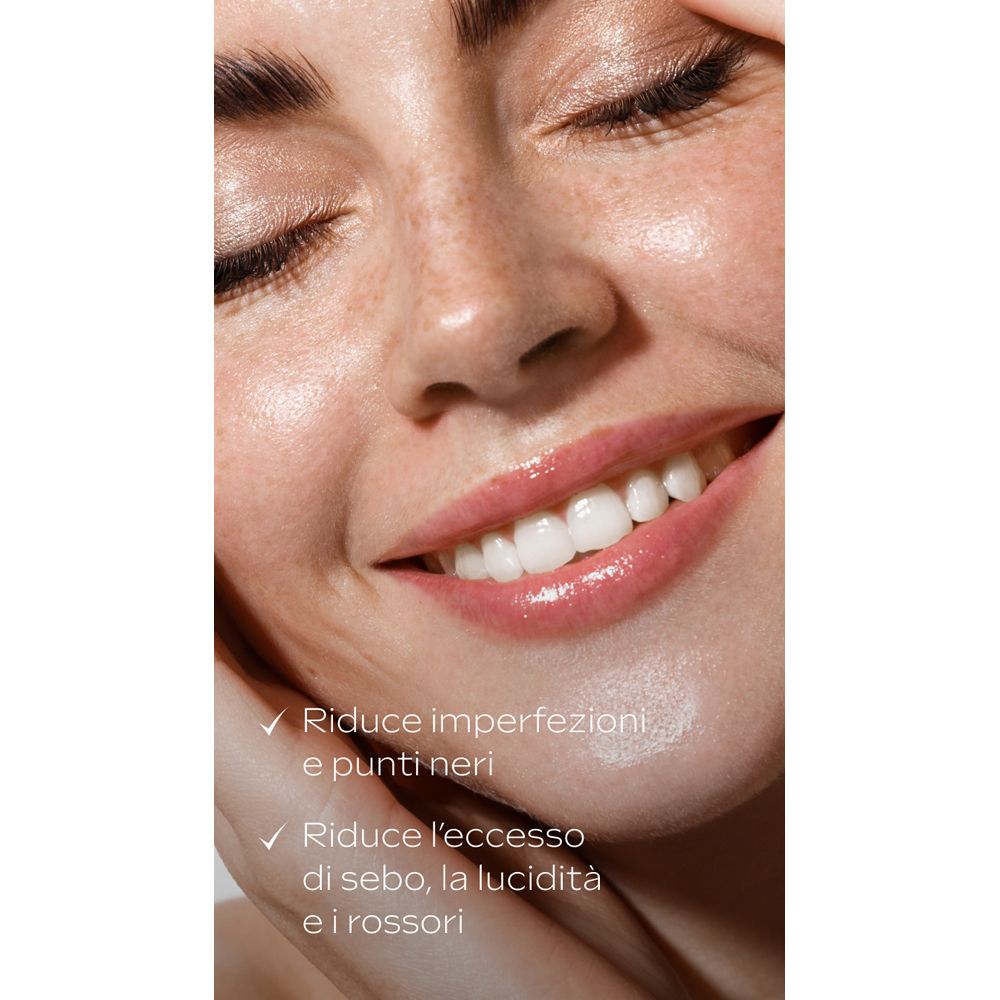 Primo piano di un viso sorridente. Testo: Riduce imperfezioni e punti neri. Riduce l'eccesso di sebo, la lucidità e i rossori.