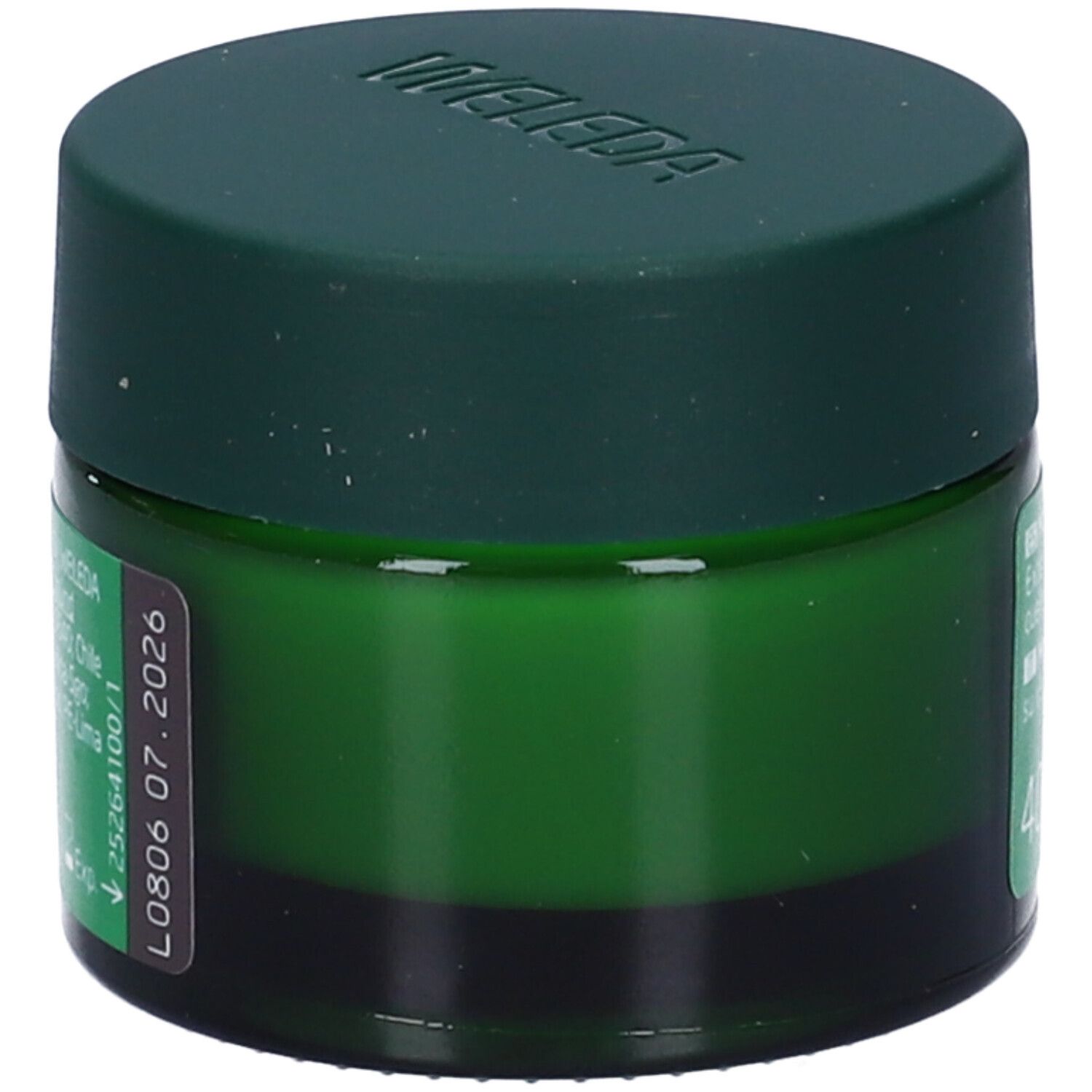 Vaso verde con crema. Scritta: WELEDA. Data di scadenza.