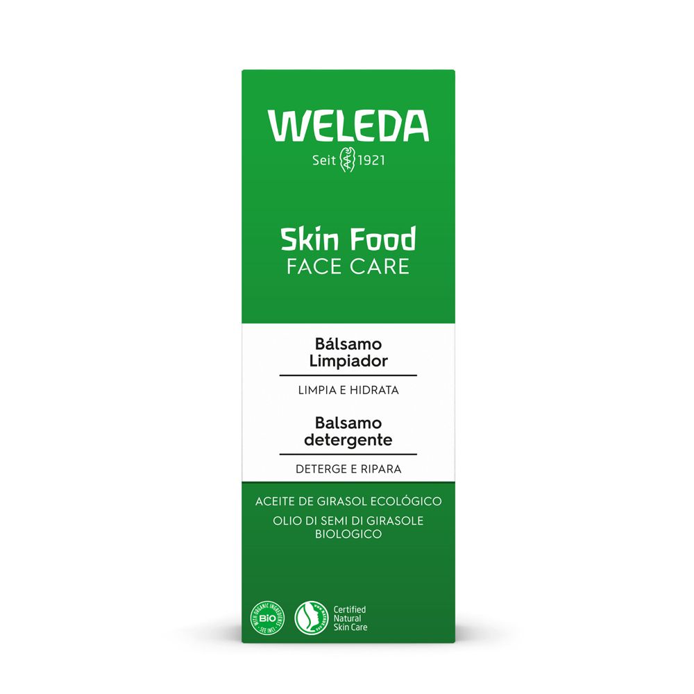 Primo piano di un tubo verde. Scritta: WELEDA, Skin Food, Face Care, Balsamo Detergente. Sigillo cosmetico naturale certificato.