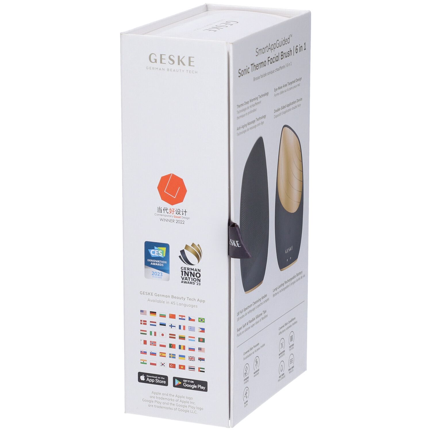 Confezione bianca con immagine del prodotto. Spazzola per la pulizia del viso ovale nera con elemento dorato. Testo: GESKE, SmartAppGuided, CES.