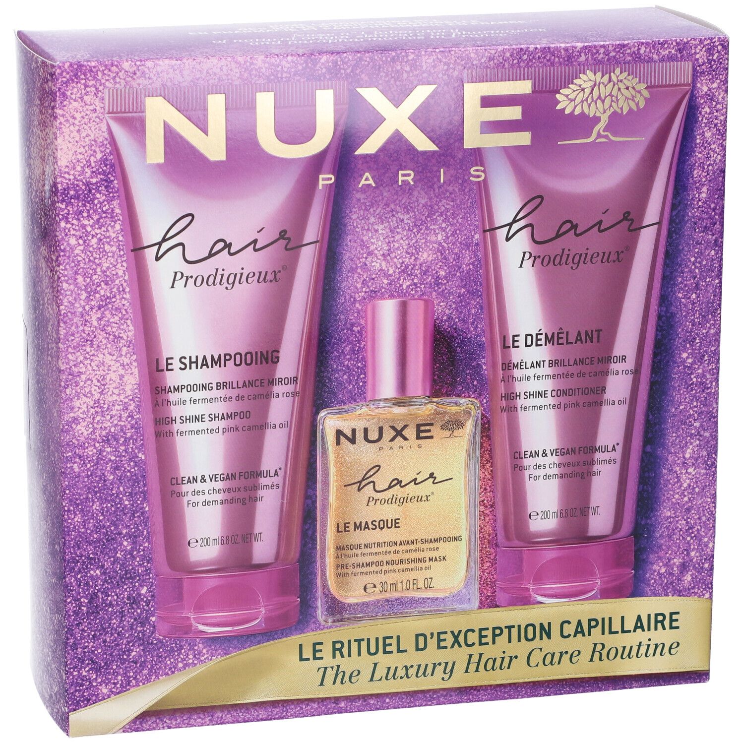 Set per la cura dei capelli Nuxe: shampoo, balsamo e maschera in confezione viola scintillante. Contiene tre tubetti viola e una bottiglia dorata.