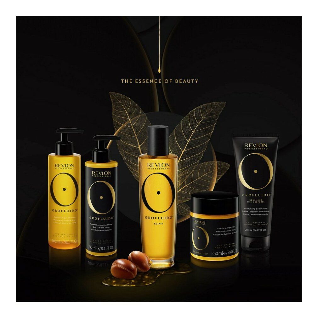 Gamma di prodotti su sfondo nero. Bottiglie, vaso e tubo con loghi e scritte dorate. Prodotti all'olio di argan.