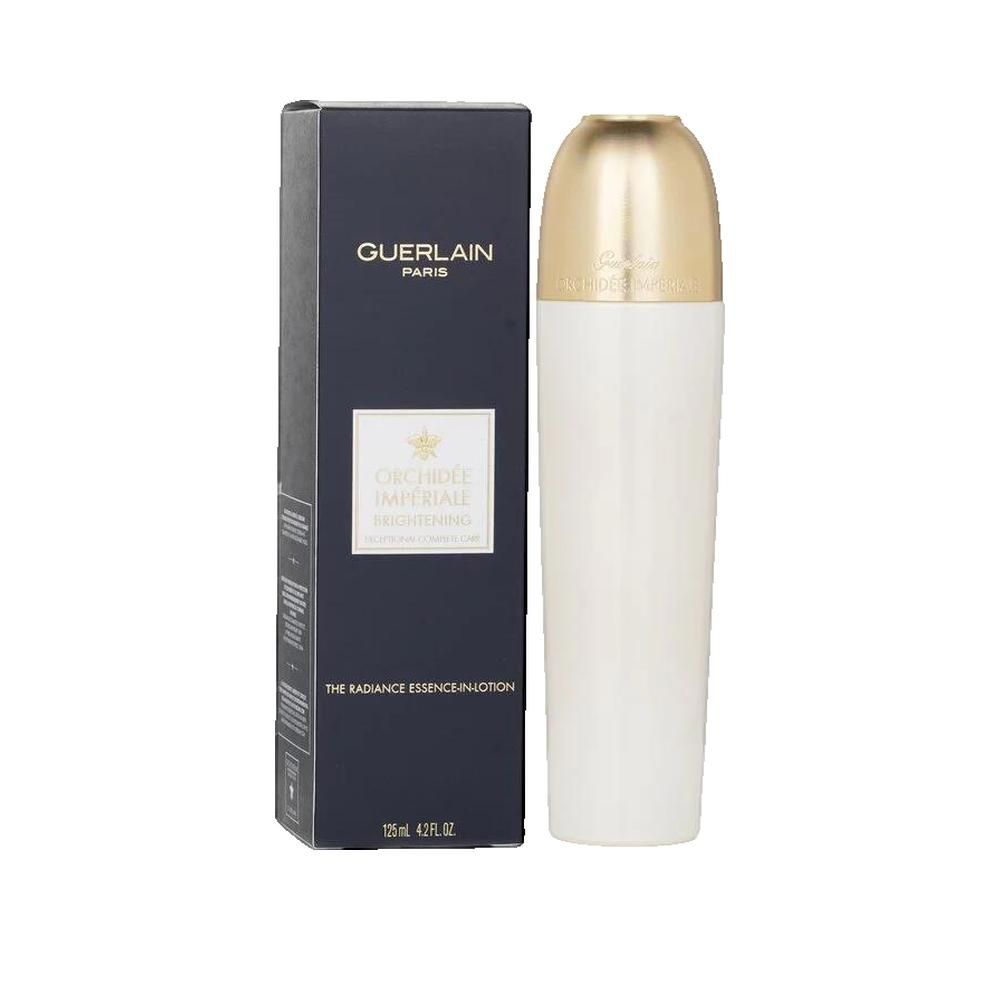 Flacone bianco con tappo dorato accanto a una scatola nera. La scatola riporta la scritta "GUERLAIN PARIS".