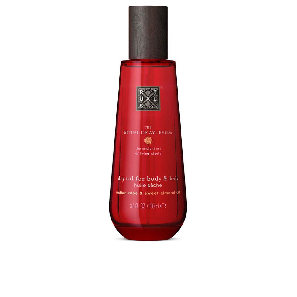 Flacone in vetro rosso con tappo in legno, Olio Secco Rituals The Ritual Of Ayurveda per corpo e capelli.