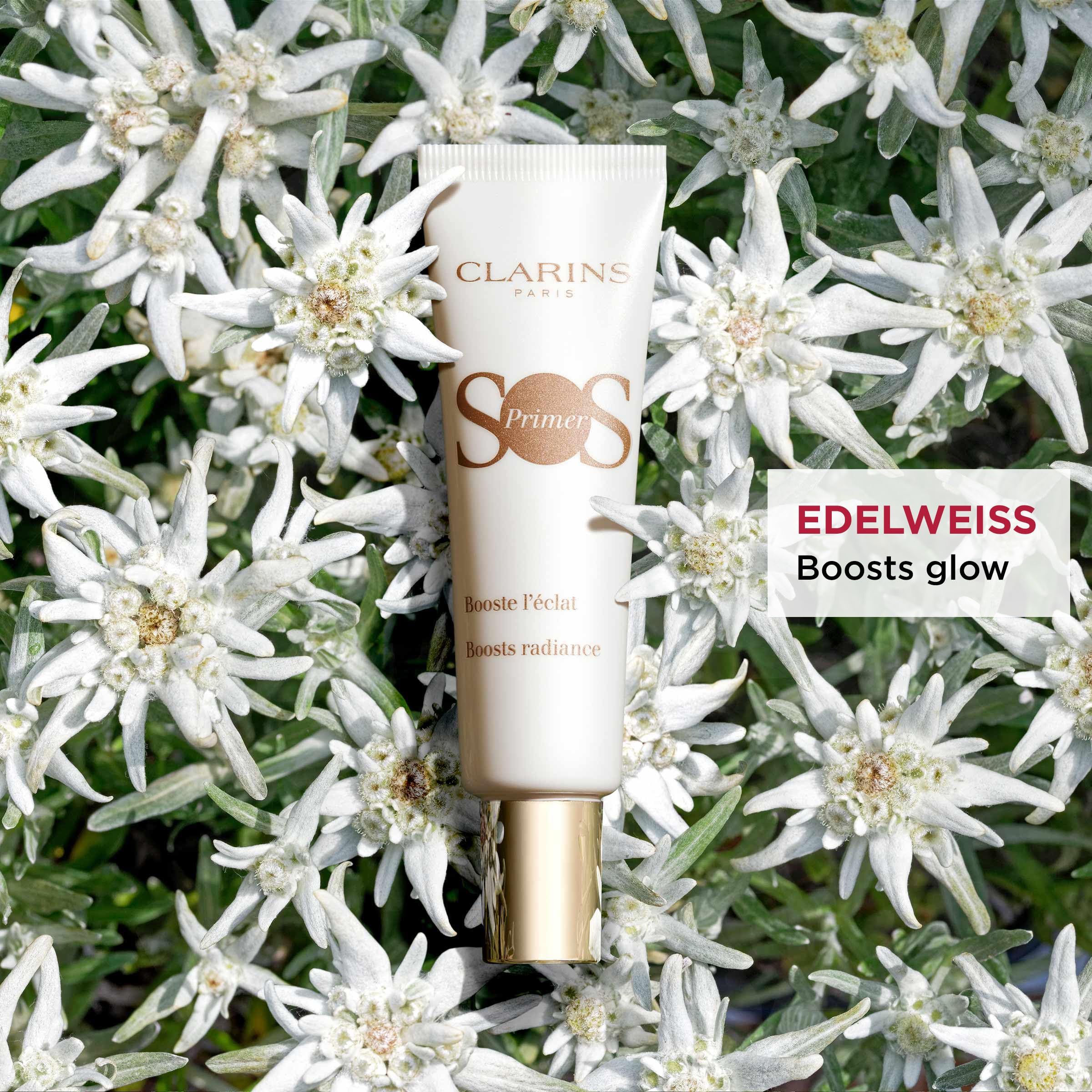 Tubo bianco con testo. Circondato da fiori bianchi. Testo: SOS Primer.