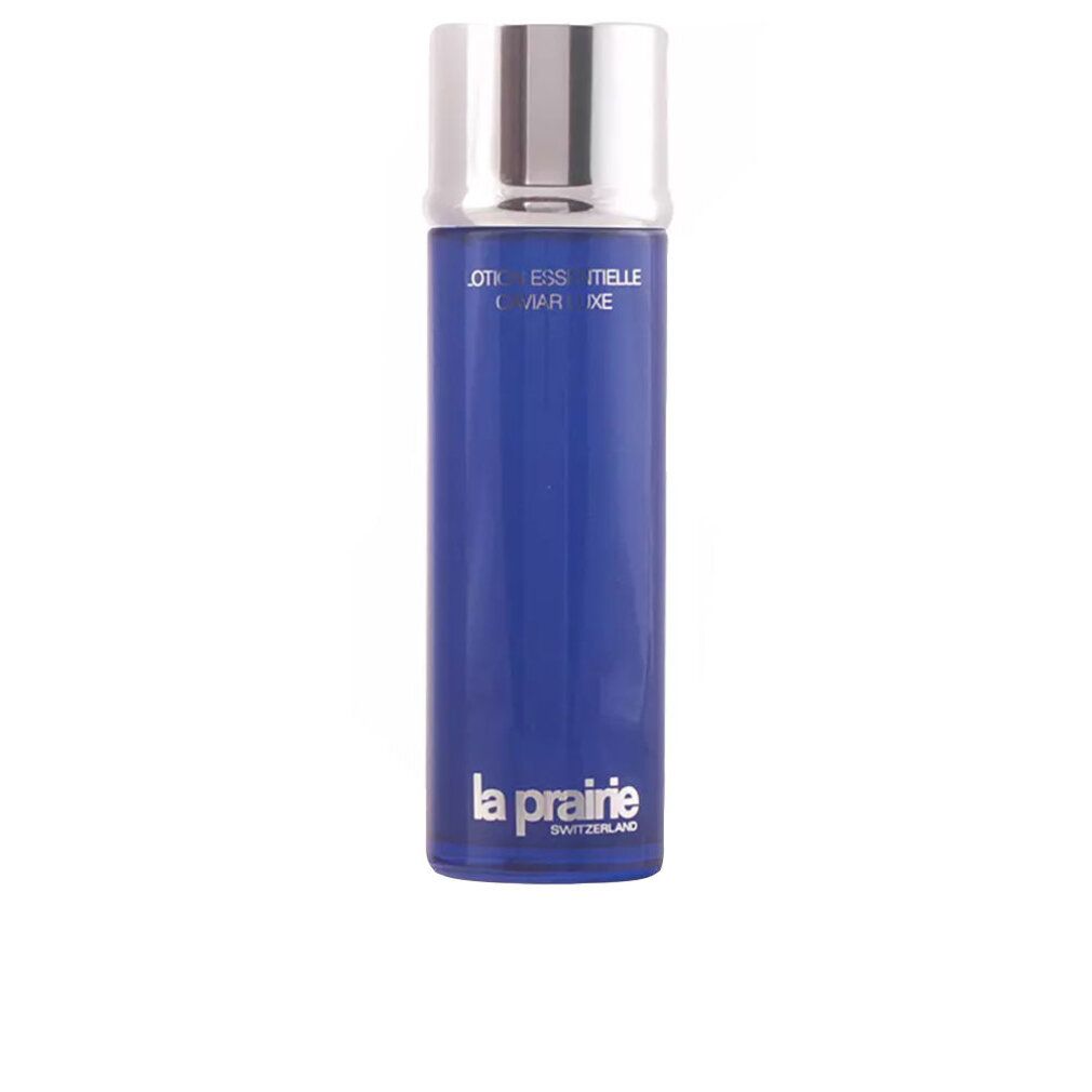 Flacone blu con tappo argentato. Scritta: Essence-in-Lotion, La Prairie.