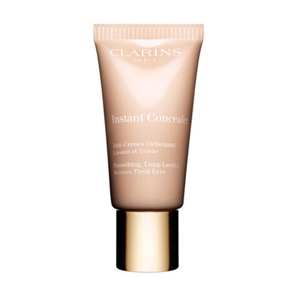 Tubo correttore beige Clarins. Scritta: Instant Concealer. Anti-Cernes Défatiguer. Levigante, lunga durata, ravviva gli occhi stanchi.
