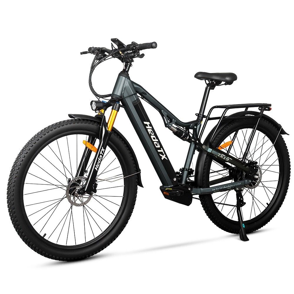 E-bike grigio HedaTX TX19. Pneumatici neri, portapacchi, sospensioni. Forcella gialla. 27 velocità. Scritta HedaTX.