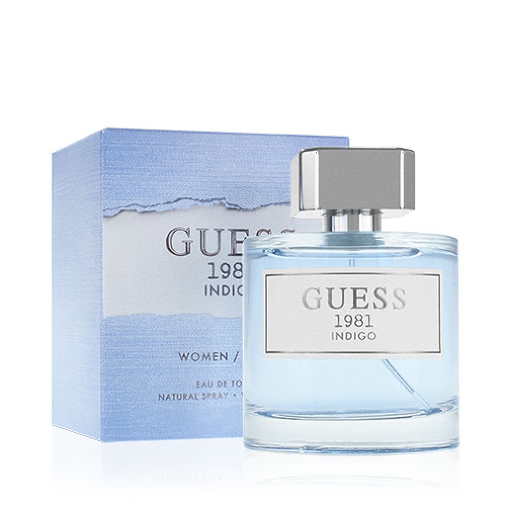 Flacone di profumo blu e scatola. Scritta: GUESS 1981 INDIGO. Eau de Toilette Spray. Per donne.