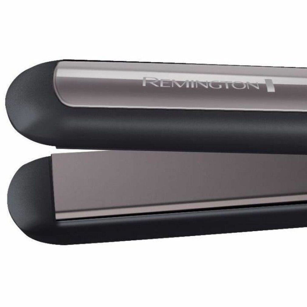 Primo piano di una piastra per capelli. Manico nero, piastre riscaldanti grigie. Marchio Remington.