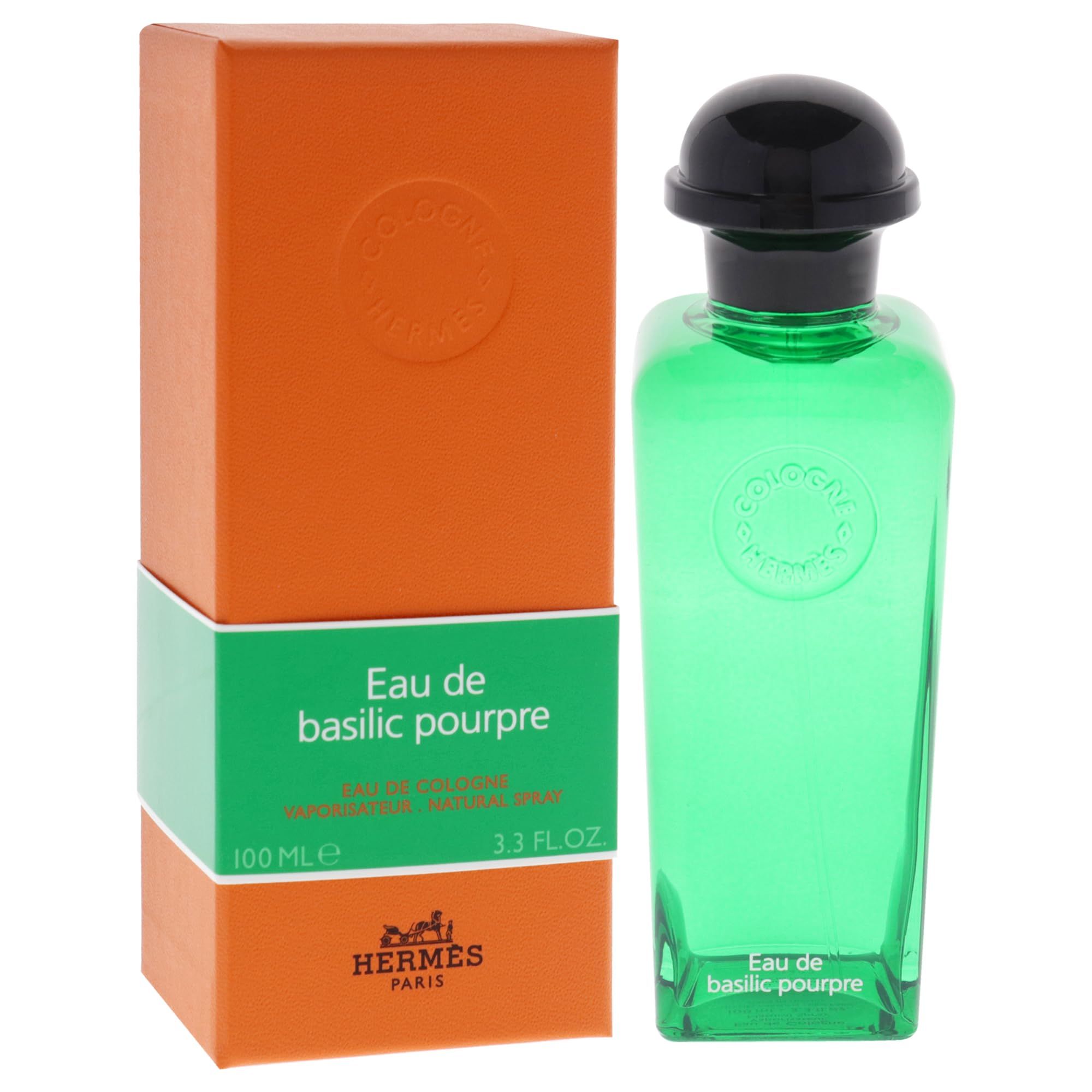 Flacone di vetro verde con tappo nero e confezione arancione. Scritta: Eau de basilic pourpre, Hermès.