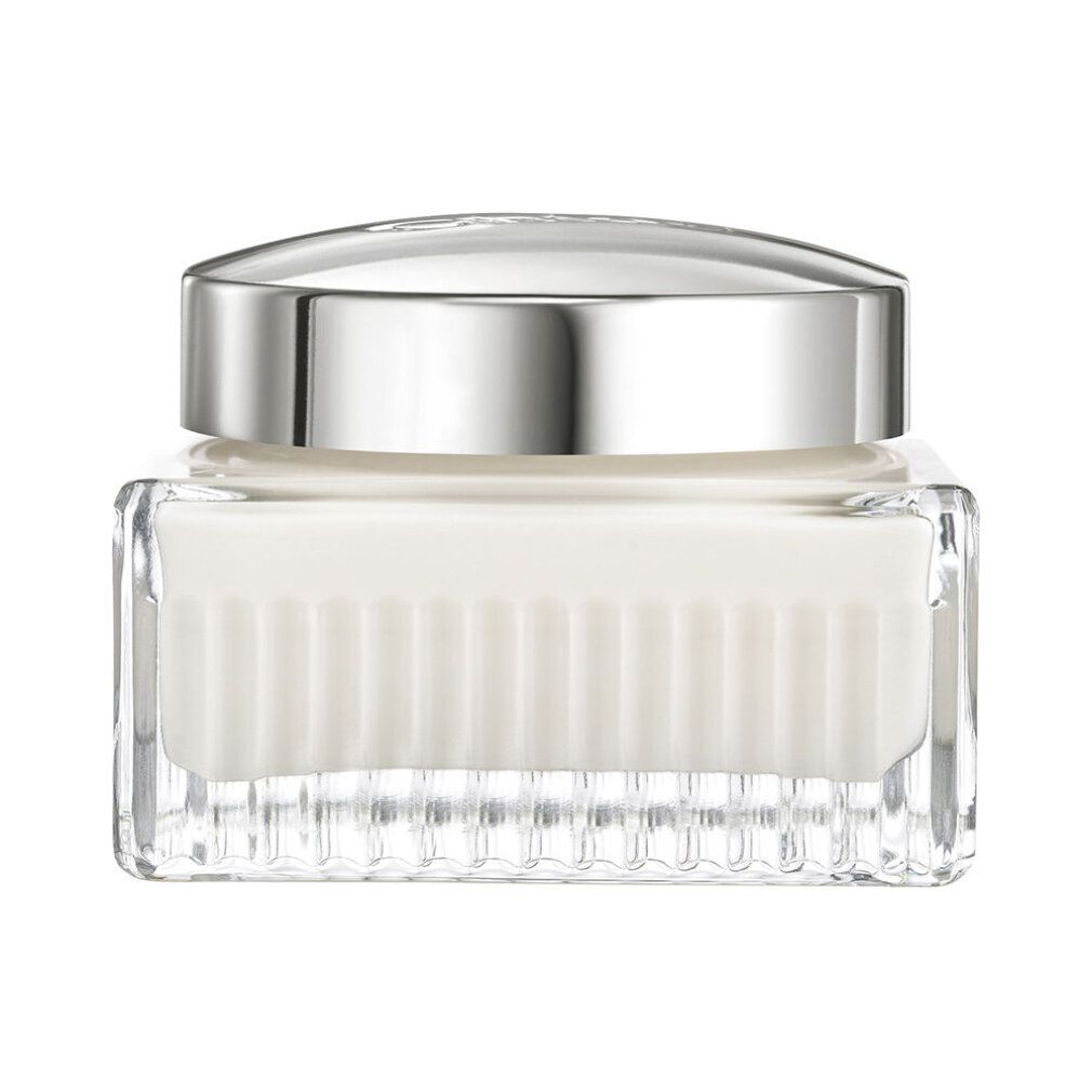 Vasetto in vetro con coperchio argentato. Contiene crema bianca. Lati scanalati. Forma quadrata.