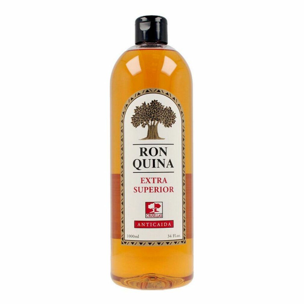 Bottiglia di liquido marrone. Etichetta con logo albero, scritta 'Ron Quina Extra Superior' e 'Anticaida'. Tappo nero.
