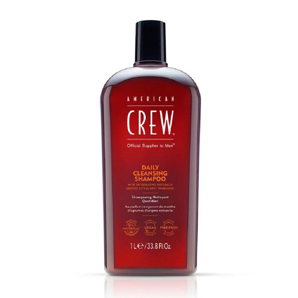 Flacone rosso American Crew Daily Shampoo. Tappo nero. Testo: Daily Cleansing Shampoo, 1L/33.8 Fl. Oz.