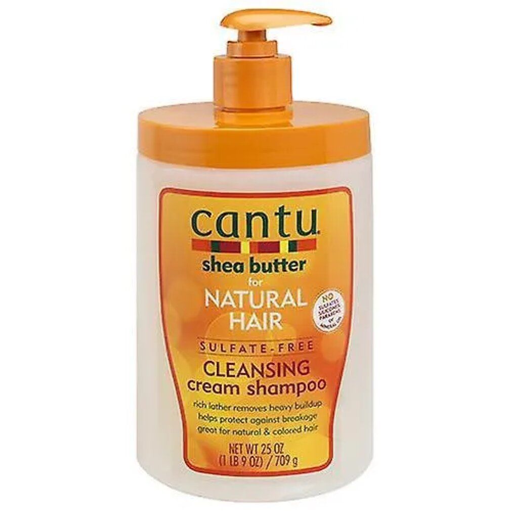 Flacone di shampoo con dosatore a pompa. Scritta: Cantu, Shea Butter, Natural Hair, Cleansing Cream Shampoo. Design arancione e bianco.