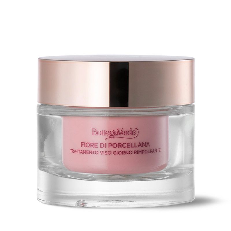 Vasetto di crema con interno rosa e coperchio dorato. Scritta: Fiore di Porcellana, Trattamento viso giorno rimpolpante.