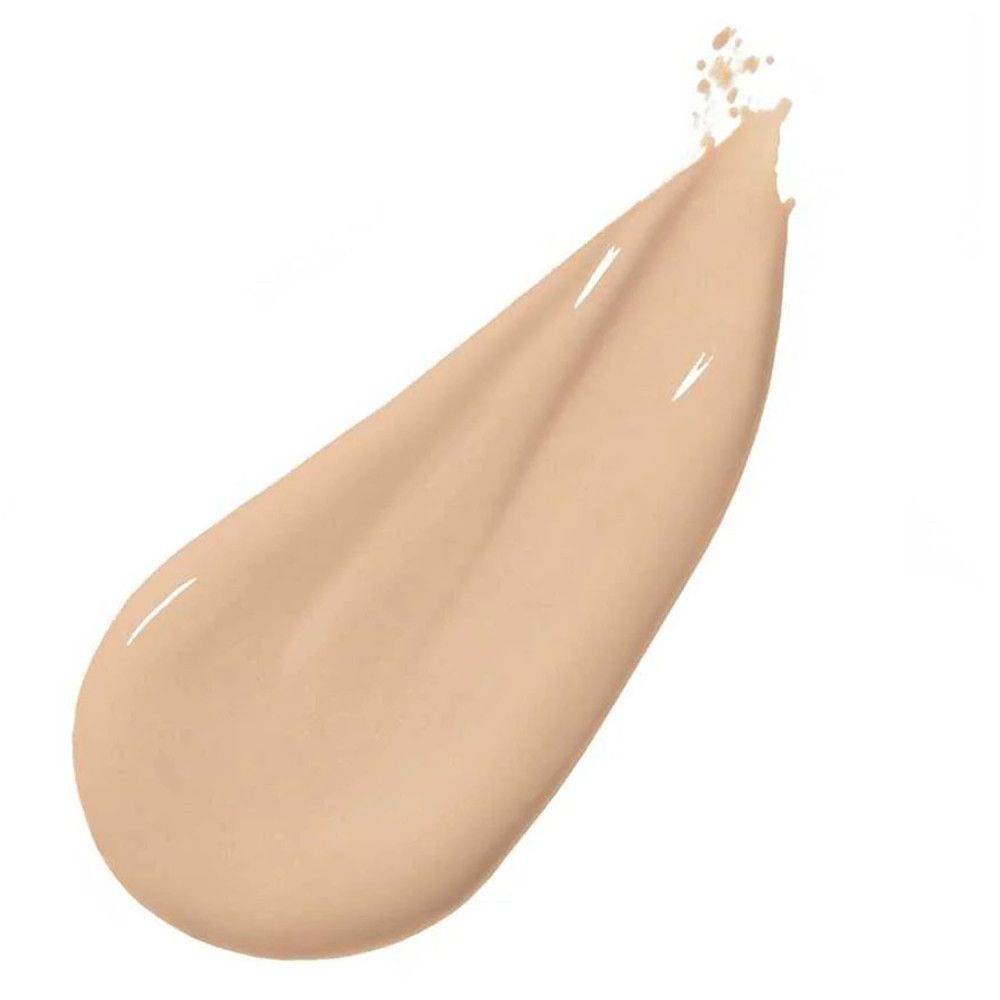 Campione di fondotinta liquido chiaro. Applicazione a goccia su sfondo bianco. Texture lucida.