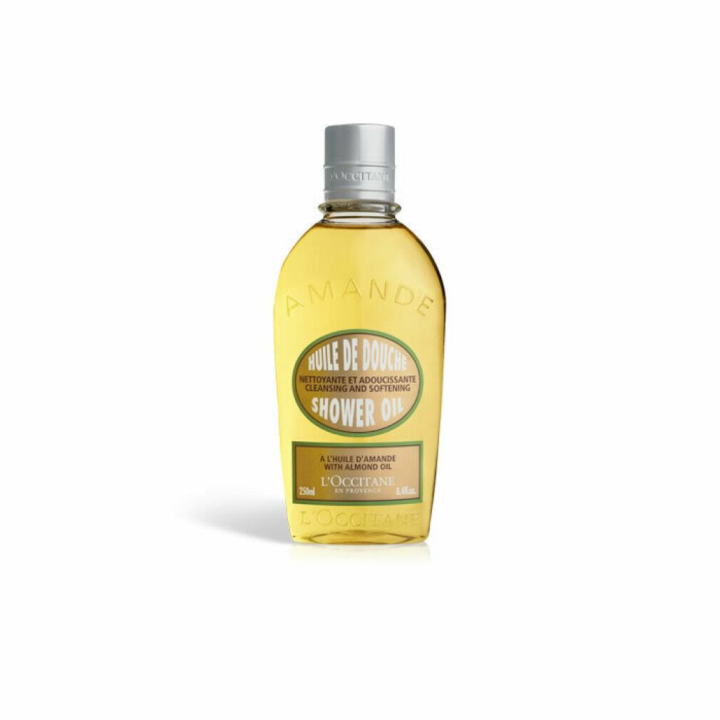Flacone ovale di olio doccia, tappo argentato. Scritta: Huile de Douche, olio di mandorle, 250ml, L'Occitane. Primo piano.